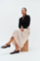 Woman sitting with arms and legs crossed