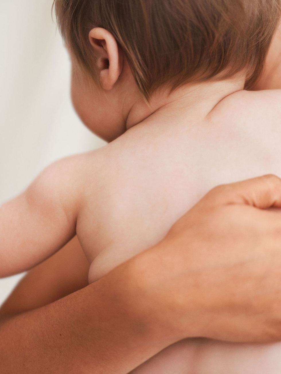 Baby being held by an adult