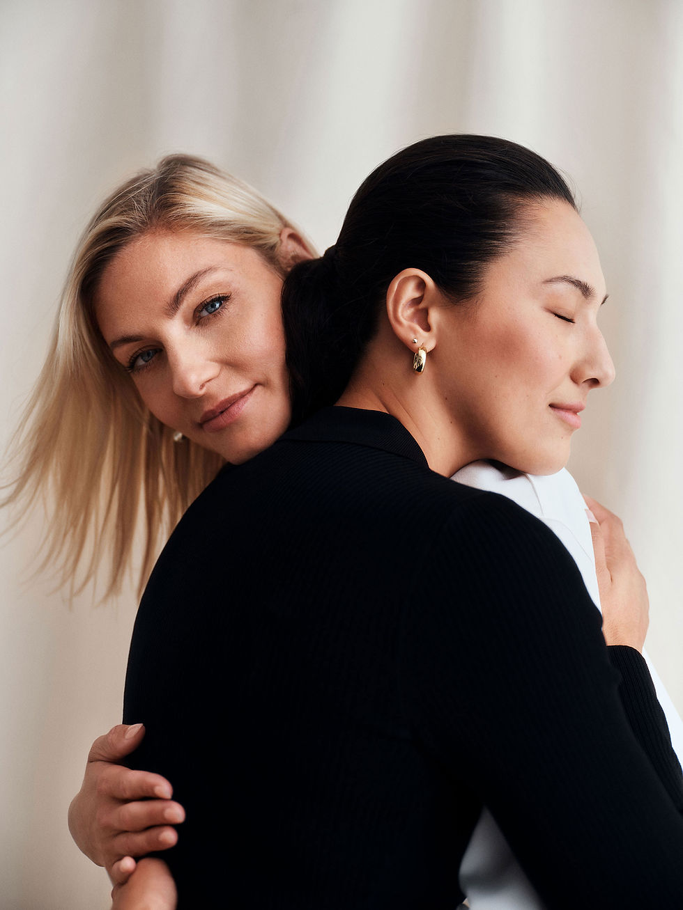 Two women embrace