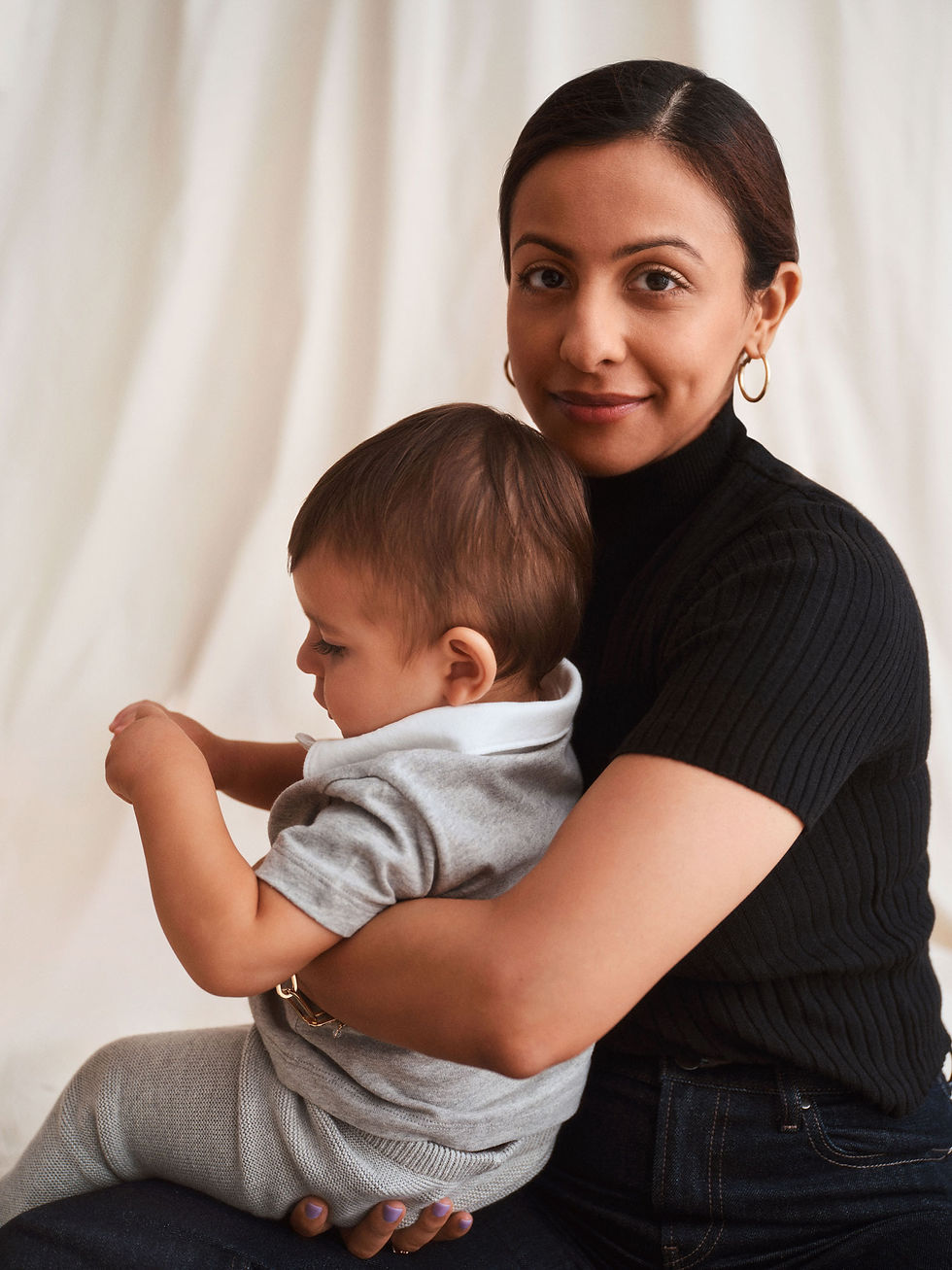 Woman holds an infant in her lap