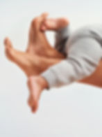 Baby laying on an adults legs